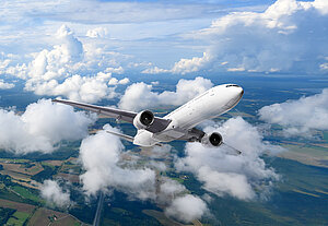 White passenger airplane flying over the clouds